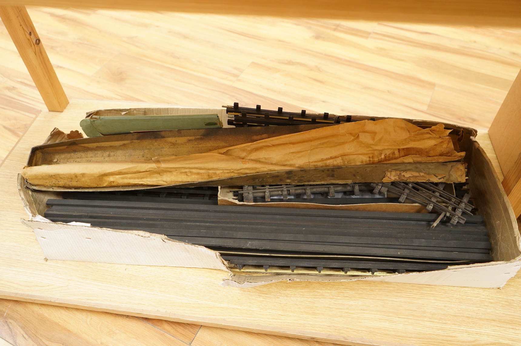 A quantity of 1930s-50s Bassett Lowke 0 gauge railway related track parts and accessories, including track sections on wooden sleepers, a Bassett-Lowke set of points, plus two handmade sets of points, track gauges, chair